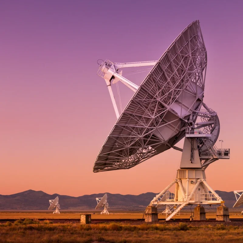 Radio telescope dishes at sunset